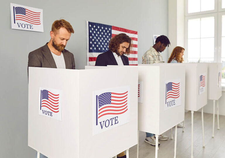 Group of diverse American citizens voting at polling station during USA presidential elections. Several people make choice and vote for different candidates in booths with US flags. Democracy concept
