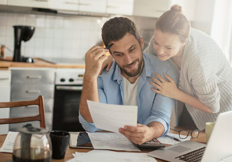 Young couple doing finances together in the kitchen