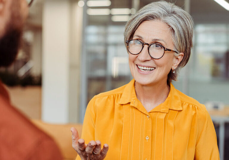 Financial advisor discussing retirement plan options with a client, illustrating tax planning for net unrealized appreciation and after-tax 401(k) contributions.