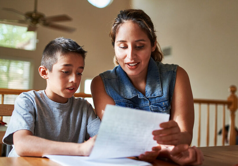Woman reviewing homework with little boy
