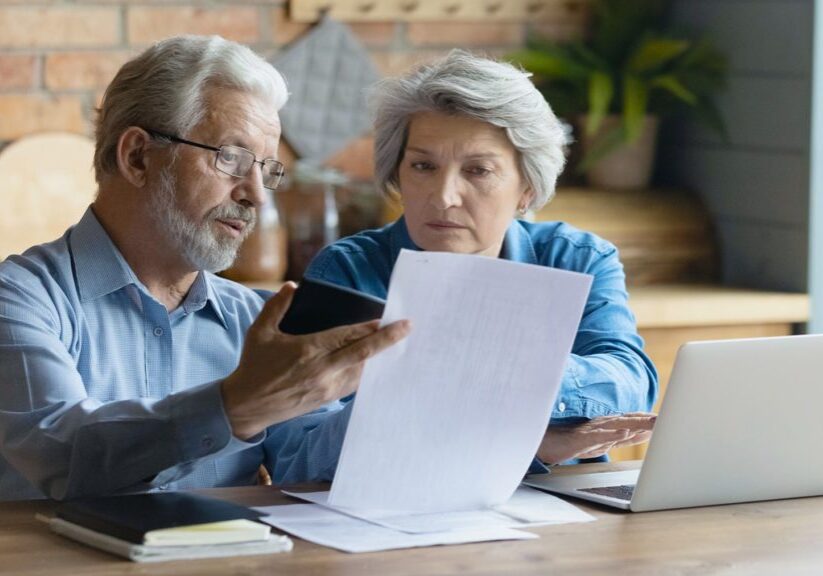 Husband and wife reviewing expenses