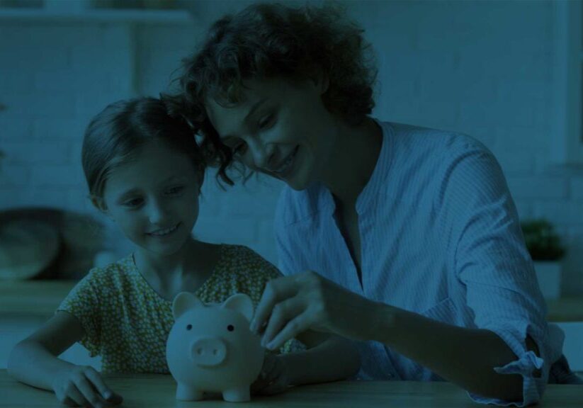 Woman and little girl with piggy bank