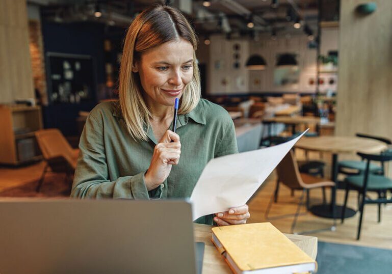 Business owner reviewing financial statements and balance sheet records for year-end tax planning