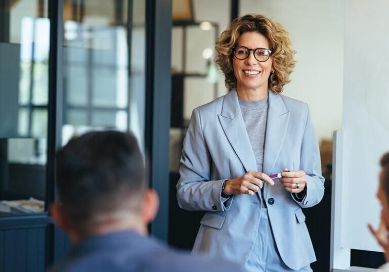 Business owner leading a strategic financial planning presentation with her team