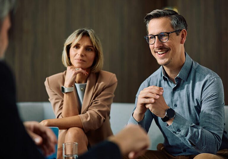 Wealthy couple meeting with a financial advisor to discuss multifamily office wealth planning